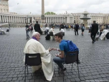 Pope Francis hears confessions of teenagers in St. Peter's Square.