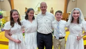 The McCoppin family (from left): Alyssa, Courteney, James, Rhys, and Kelly, poses for a photo after entering the Catholic Church at the Easter Vigil on April 8, 2023, at Sacred Heart Church in Manassas.